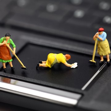 registry cleaners regclean pro toy figurines cleaning people on black laptop pad